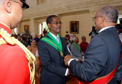 Governor General, His Excellency the Most Hon. Professor Kenneth Hall (right), presents the instrument of appointment to President of the Court of Appeal, Justice Seymour Panton, at the official swearing-in ceremony held on July 6 at King's House.