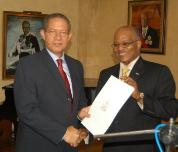 Prime Minister Bruce Golding (left), accepts the proclamation officially declaring February as Reggae Month, from Governor General, His Excellency, the Most Hon. Professor Sir Kenneth Hall during the ceremony to launch the event at King's House