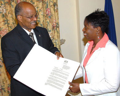 Governor General, His Excellency, The Most Honourable Professor Sir Kenneth Hall (left) presents the Proclamation formally declaring April 13-19 as Special Libraries Week, to Chairperson, Special Libraries Section, Claudia Sutherland, following its reading at King's House on Thursday (April 10). The Proclamation was read by Sir Kenneth. 