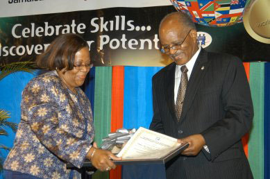 Governor General, His Excellency the Most. Hon. Professor Sir Kenneth Hall, is presented with an honorary Level V National Vocational Qualification of Jamaica (NVQ-J) in Education Leadership by Senior Director of the National Council of Technical and Vocational Education and Training (NCTVET), Paulette Dunn-Smith. The presentation was made during the official opening ceremony for the third annual World Skills Jamaica National Skills Competition at the National Indoor Sports Centre in Kingston on Wednesday (April 23). Close to 1000 students drawn from HEART Trust institutions are participating in the two-day event.