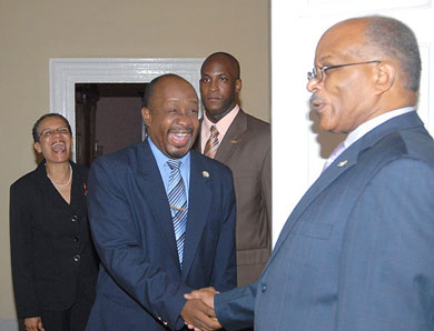 Governor-General, His Excellency the Most Hon. Professor Sir Kenneth Hall (right), welcomes President of the Press Association of Jamaica, Byron Buckley, when he visited King's House on December 1. The President was accompanied by First Vice President of the Association, Fae Ellington (left). At second right is the Governor-General's Aide-de Camp, Captain Delano Coriah.