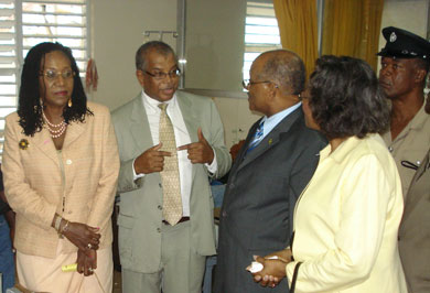 Senior Medical Officer at the St. Ann's Bay Hospital, Dr. Horace Betton (second left), in discussion with Governor-General, His Excellency the Most Hon. Professor Sir Kenneth Hall and Lady Hall, when they visited and toured the hospital on December 15. At left is Norma Walters, wife of the Custos of St. Ann, and at right is Deputy Superintendent of Police, Richard Brown.