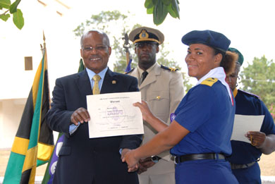 Governor-General, His Excellency the Most Hon. Professor Sir Kenneth Hall (left), presents a certificate to Assistant Cub Scout Leader, St. James District, Mercedes Jones, during a ceremony held at King's House, on February 19. At centre is the Governor-General's Aide-de-Camp, Captain Delando Coriah.