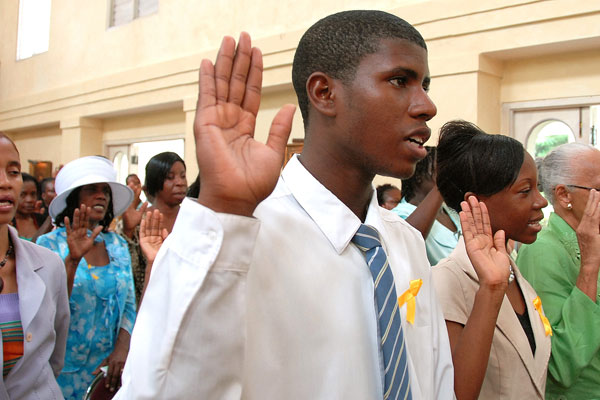 Volunteers with the Jamaican Foundation for Lifelong Learning (JFLL) take their oath during the swearing in ceremony held today (June 23) at King's House. Governor General, His Excellency the Most Hon. Sir Patrick Allen, presided over the ceremony.