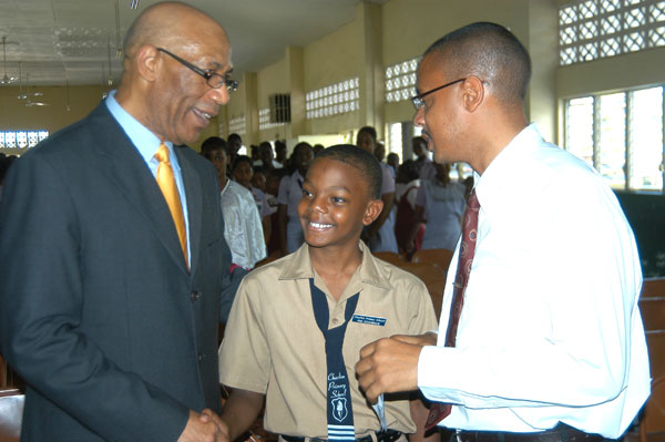 Governor-General, His Excellency the Most Hon. Sir Patrick Allen (L) greets student of Charlton Primary School in Alexandria, St. Ann, Karl Brown (C), while Karl Brown Sr., who is a Guidance Counsellor at the Brown's Town High School, shares the moment. His Excellency visited St. Ann yesterday (June 24), which was his first stop on his island-wide tour.