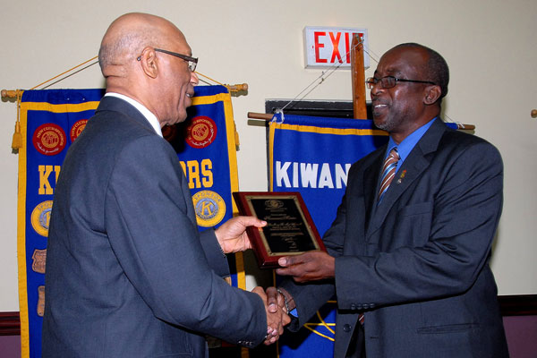 Governor-General, His Excellency the Most Hon. Sir Patrick Allen receives a plaque signifying his acceptance into the Kiwanis Club of Kingston as an honorary member, from the President, Ralston Nunes, during Tuesday's (July 14) luncheon meeting at the Hilton Kingston Hotel.