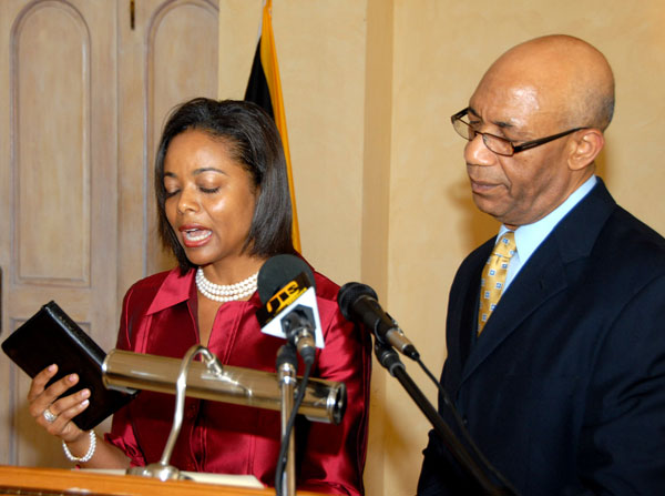 Governor-General, His Excellency the Most Hon. Sir Patrick Allen (right) looks on as Mrs Marlene Malahoo Forte takes the Oath of Allegiance and Oath of Office as a Senator, and Minister of State in the Ministry of Foreign Affairs and Foreign Trade, during a ceremony held at King's House on Wednesday (July 15).