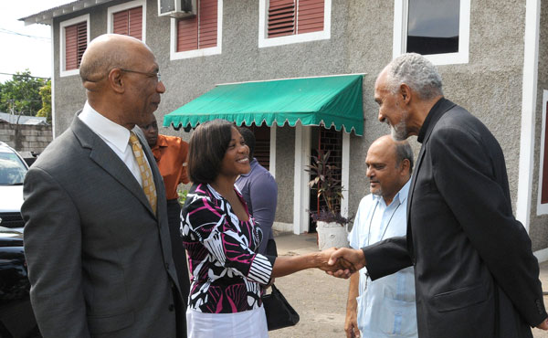 Governor-General, His Excellency the Most Hon. Sir Patrick Allen (left) and Executive Director and Founder of the Mustard Seed Communities, Father Gregory Ramkissoon (second right), look on as Lady Allen (second left), is greeted by Chairman, Board of Directors, Mustard Seed Communities, His Grace, the Most Reverend Donald Reese, during a tour of 'My Father's House', located at 1Mahoe Drive, in Kingston, today (July 27). 'My Father's House' is the headquarters of the Mustard Seed Communities. While on tour, Their Excellencies visited the dormitories, the ceramic studio, meditation garden, the Little Angels Learning Centre and the studios of ROOTS 96.1 FM, where they participated in a live radio interview. The facility, which was opened in 1989, cares for abandoned children with disabilities.