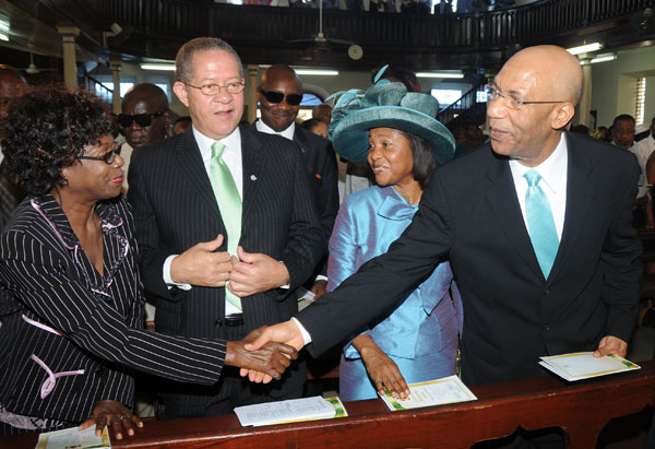 Governor-General, His Excellency Sir Patrick Allen (right) greets the wife of the Prime Minister, Mrs. Lorna Golding (left), while Prime Minister Bruce Golding and Lady Allen look during Sunday's (August 2) National Emancipation Thanksgiving Service at the East Queen Street Baptist Church, downtown Kingston, which was held under the theme 'I Believe in Jamaica'.