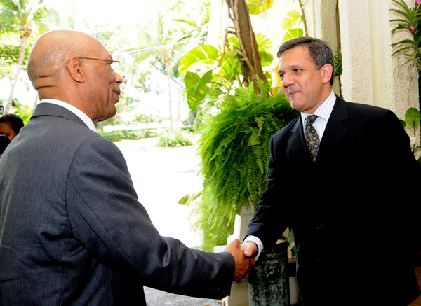 Governor-General, His Excellency the Most Hon. Sir Patrick Allen (left) being greeted by President and Chief Executive Officer (CEO) of the Jamaica Public Service (JPS) Company, Damian Obiglio, at the luncheon marking the presentation of grants for tertiary education, at the Terra Nova All Suites Hotel, Kingston, on Tuesday (August 11). The JPS presented $8 million to assist students in need of financial assistance to four institutions - University of Technology (UTech), University of the West Indies (UWI), Northern Caribbean University (NCU) and the St. Patrick's Foundation.