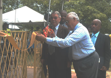 Minister of Transport and Works, and Member of Parliament for Central Clarendon, Hon. Mike Henry, cuts the ribbon to officially open the Clarendon Peace and Justice Centre, in May Pen, on August 18. Others sharing in the occasion are (from left): Custos of Clarendon, Hon. Robert DeRoux; Permanent Secretary in the Ministry of Justice, Robert Rainford; and Mayor of May Pen, Councillor Milton Brown.