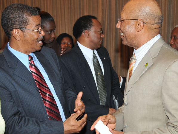 Governor-General, His Excellency the Most Hon. Sir Patrick Allen (right), having a light discussion with President of the Kingston Chapter of the Lay Magistrates' Association of Jamaica, Hugh Cross (left), when he arrived at the Jamaica Pegasus Hotel, in Kingston, today (September 9), for a meeting with Custos of Kingston, Rev. Canon, the Hon. Weeville Gordon, Justices of the Peace (JPs) from Kingston, and members of the Kingston Chapter of the Lay Magistrates' Association of Jamaica.