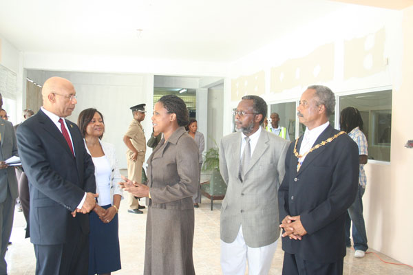 Chief Librarian at the Hanover Parish Library, Miss Merveta Stewart (3rd left), in discussion with Their Excellencies, Governor-General, His Excellency The Most Honourable Sir Patrick Allen (left) and Lady Allen (2nd left), after the Governor-General officially opened an exhibition to commemorate the life and work of the late cultural icon, Hon. Louise Bennett-Coverley. Looking on are: Custos of Hanover, the Hon. Dr. David Stair (2nd right) and His Worship the Mayor of Lucea, Councillor Lloyd Hill.