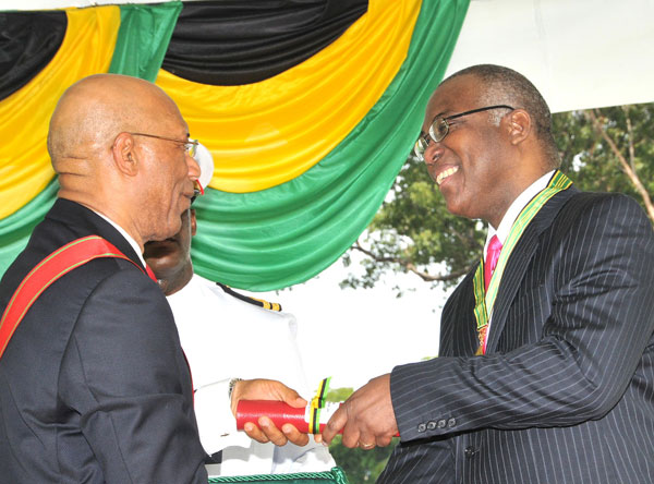 Governor-General, His Excellency the Most Hon. Sir Patrick Allen (left), presents Chief State Liaison at the Jamaica Information Service, Mr. Ian Boyne (right), with the Order of Distinction,  Commander Class, for his contribution to the field of Journalism, at the National Honours and Awards Ceremony, held today (October  19), at King’s House. 