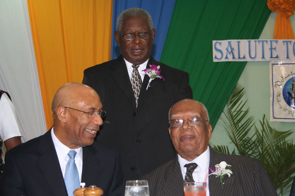 Custos of Trelawny, Hon. Royland Barrett (standing centre) has a moment with Governor General, His Excellency the Most Hon. Sir Patrick Allen (left), and former Governor General, His Excellency the Most Hon. Sir Howard Cooke, at a ceremony held to honour the Custos yesterday (Nov.11) at the Starfish Resort in Trelawny.