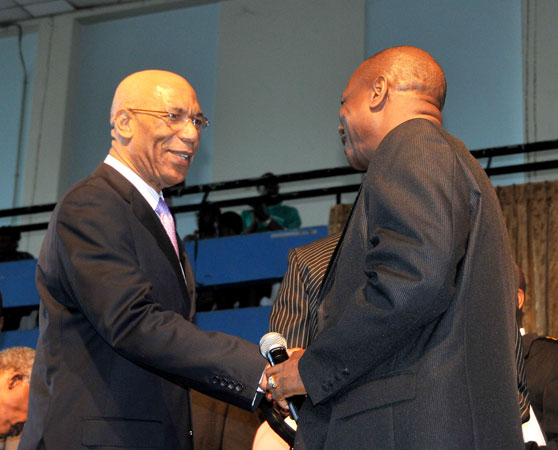 Governor-General, His Excellency, the Most Hon. Sir Patrick Allen (left) is greeted by founder of Power of Faith Ministries in Portmore, St. Catherine, Bishop Dr. Delford Davis, when he arrived for the Ministry's national prayer gathering held at the National Arena on Wednesday, January 6.