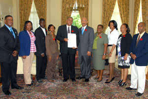 Governor General, His Excellency the Most Hon. Sir Patrick Allen (fifth right), and Executive Director, National Council on Drug Abuse (NCDA), Michael Tucker (fifth left), along with members of the NCDA following a proclamation ceremony declaring November as Drug Awareness Month, at King’s House on Monday (October 31).