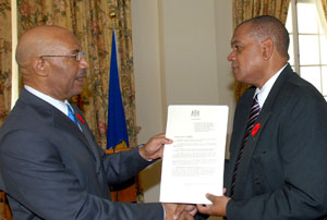 Governor General, His Excellency the Most Hon. Sir Patrick Allen (left), presents Executive Director, National Council on Drug Abuse (NCDA), Michael Tucker, with a copy of the proclamation declaring November Drug Awareness Month, following a ceremony at King’s House on Monday (October 31).