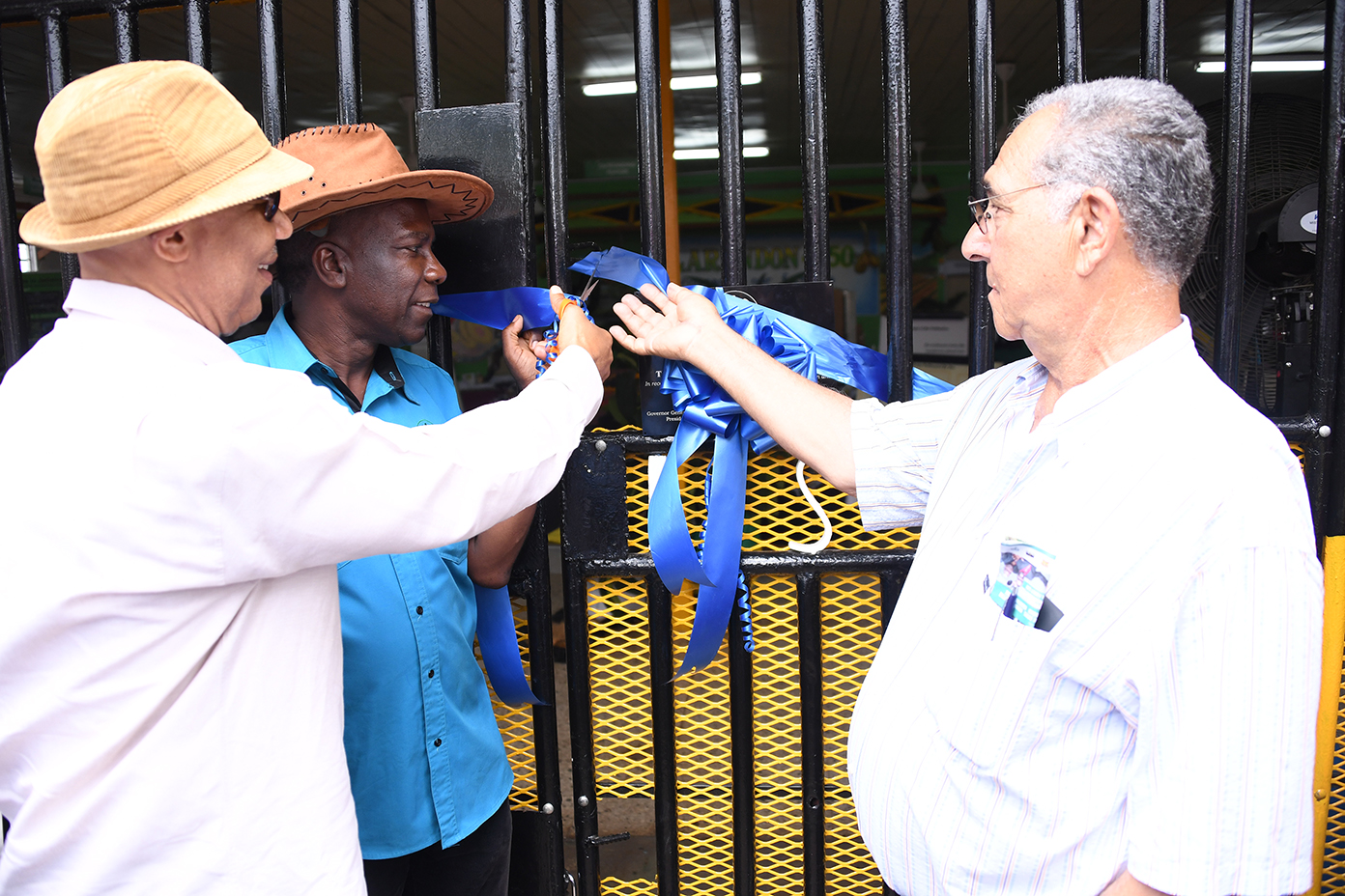 His Excellency Sir Patrick Allen (left) officially opens The Honourable William Shagoury Building. Looking on are the Hon William Shagoury, Custos of Clarendon, (right) and President of Jamaica Agricultural Society, Mr. Norman Grant.