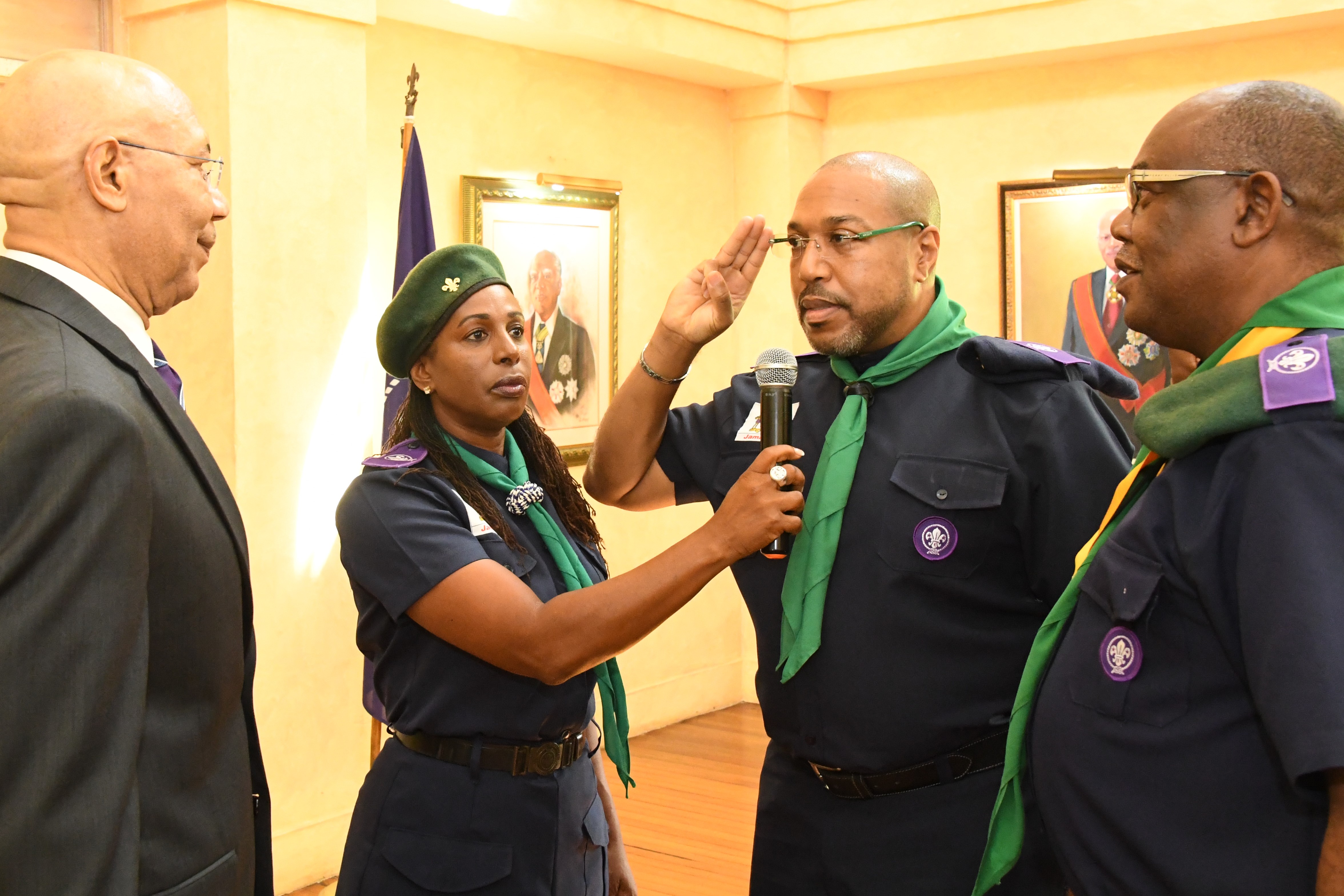 Governor-General Sir Patrick Allen and Chief Scout (left) receives a salute from new President of the Scout Association of Jamaica Mr. Richard Simpson (second right) at the Promise Renewal Investiture Ceremony held at King’s House on Friday, October 6. Looking on (right) is Mr. Maurice Brown Chief Commissioner while Mrs. Karen Harriott Wilson (second left) assists with the proceedings.  