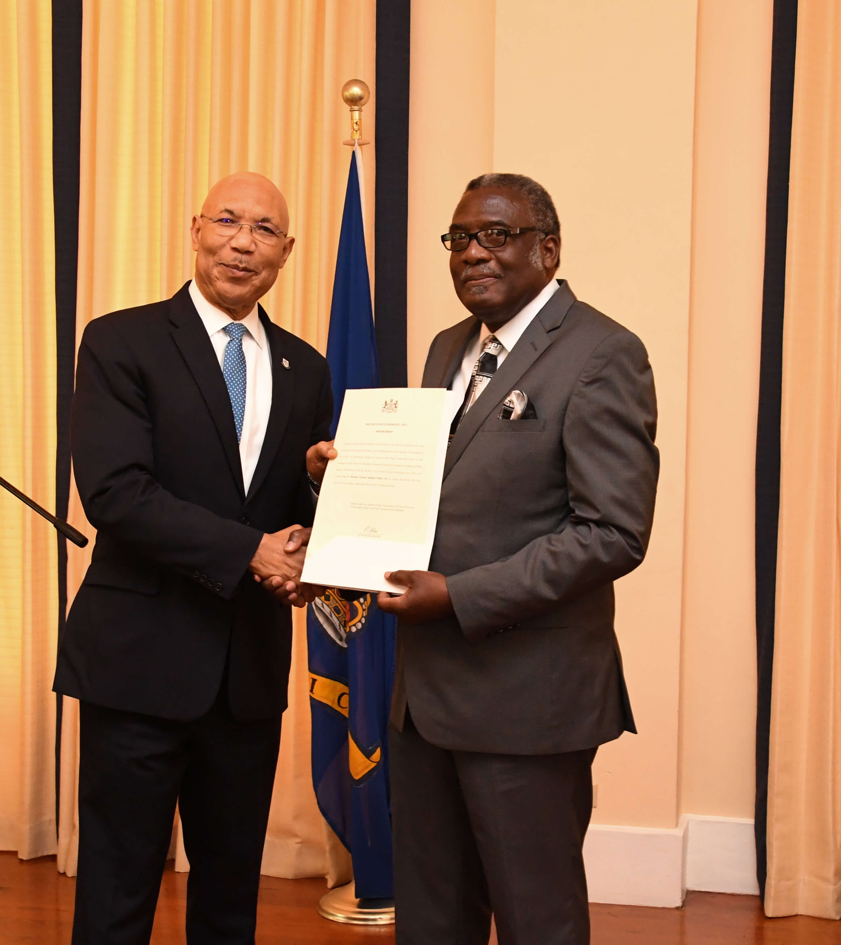 His Excellency the Most Honourable Sir Patrick Allen presents Bishop Conrad Pitkin with his Instrument of Appointment as Custos Rotulorum for the parish of St. James at King’s House on January 29, 2018. 