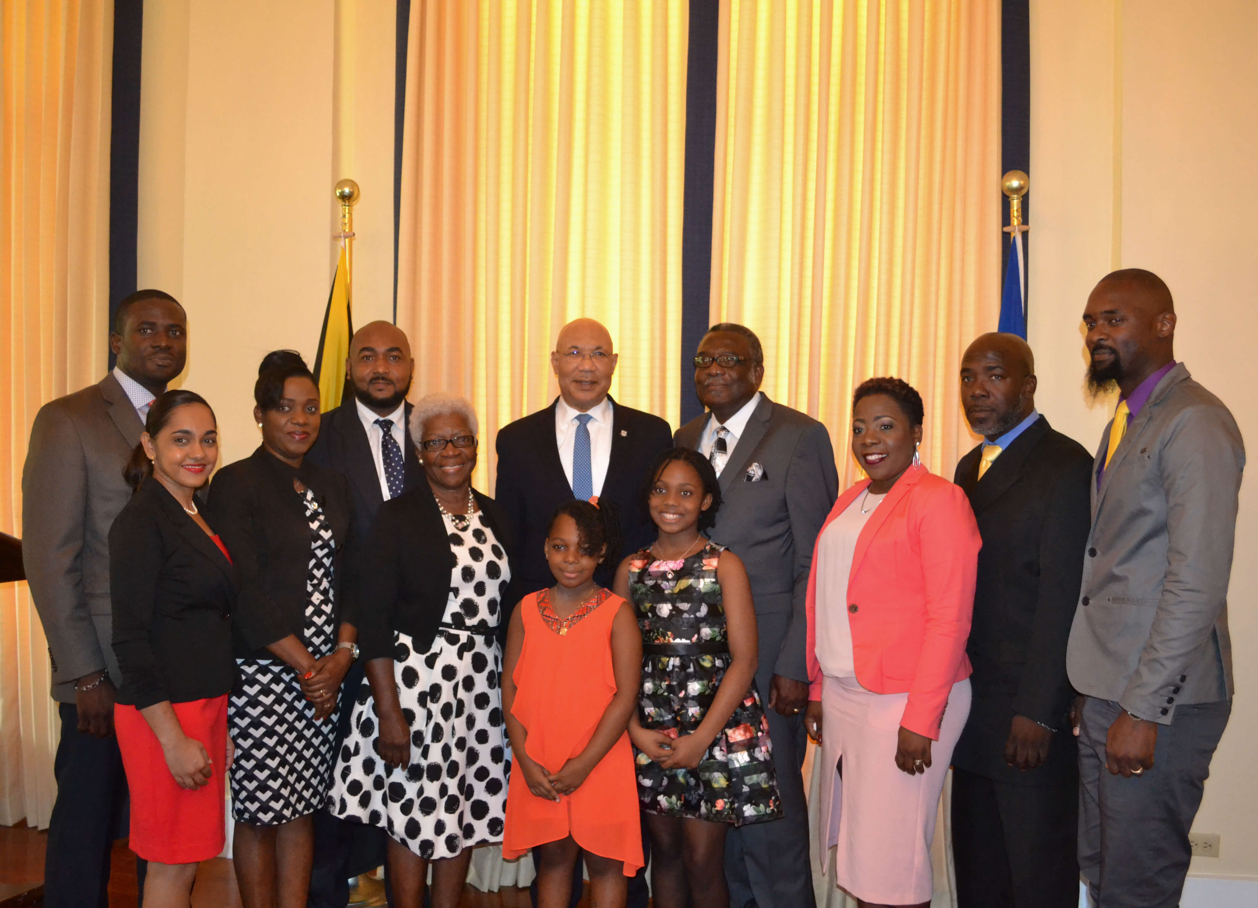 His Excellency the Most Honourable Sir Patrick Allen shares lens with Bishop Conrad Pitkin and his family following his swearing-in ceremony at King’s House on January 29, 2018.