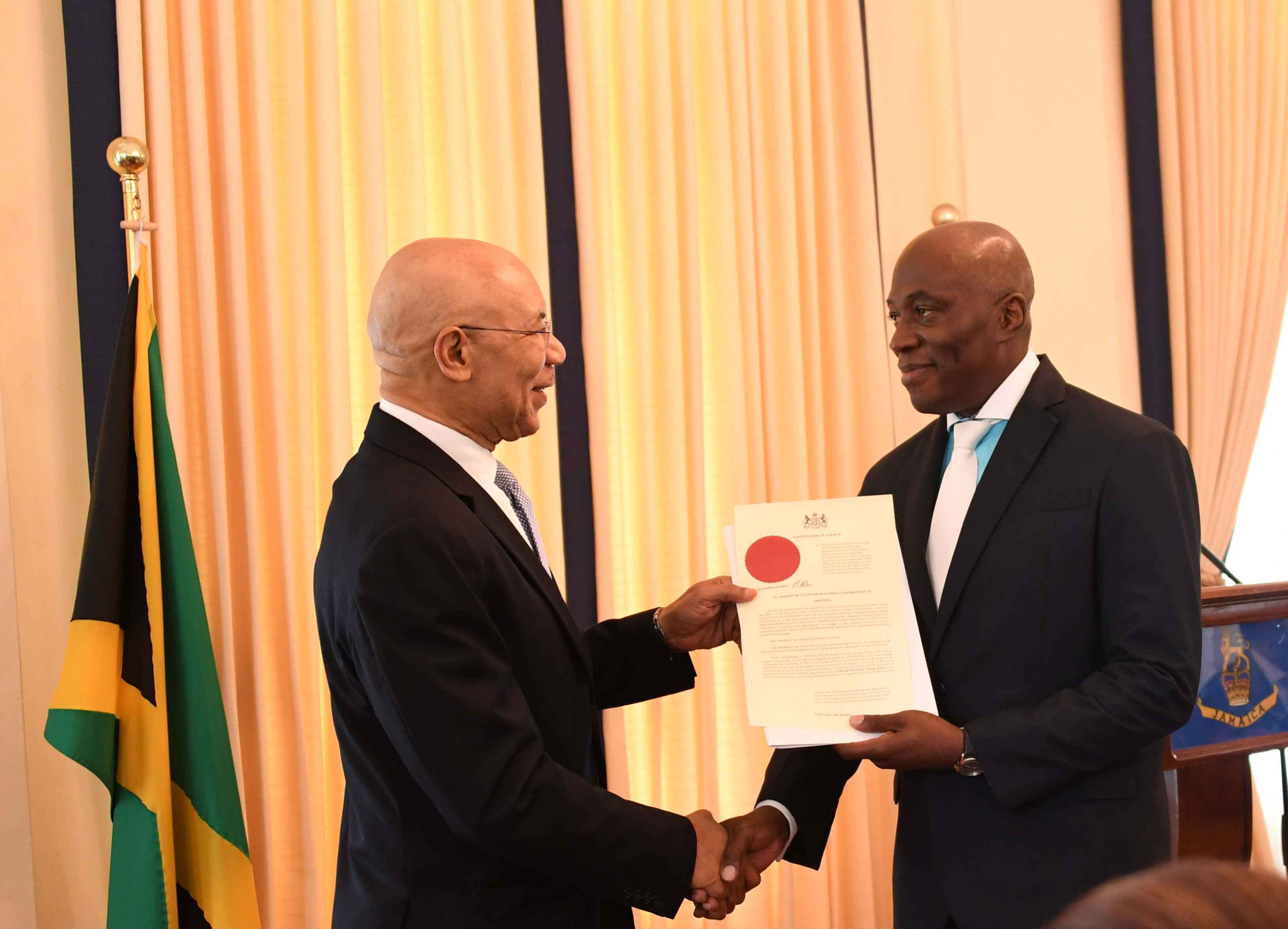 His Excellency The Governor-General presents the Honourable Mr.  Justice Bryan Sykes with his Instrument of Appointment as Chief Justice of Jamaica at a swearing-in ceremony held at King’s House on February 1, 2018.